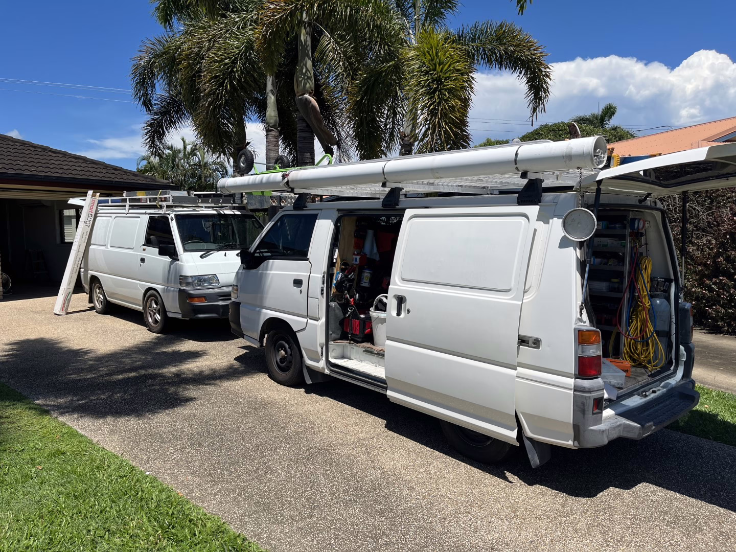 PowerControl Industries service vehicles parked at a residential property during an electrical installation {{brizy_dc_image_alt imageSrc=