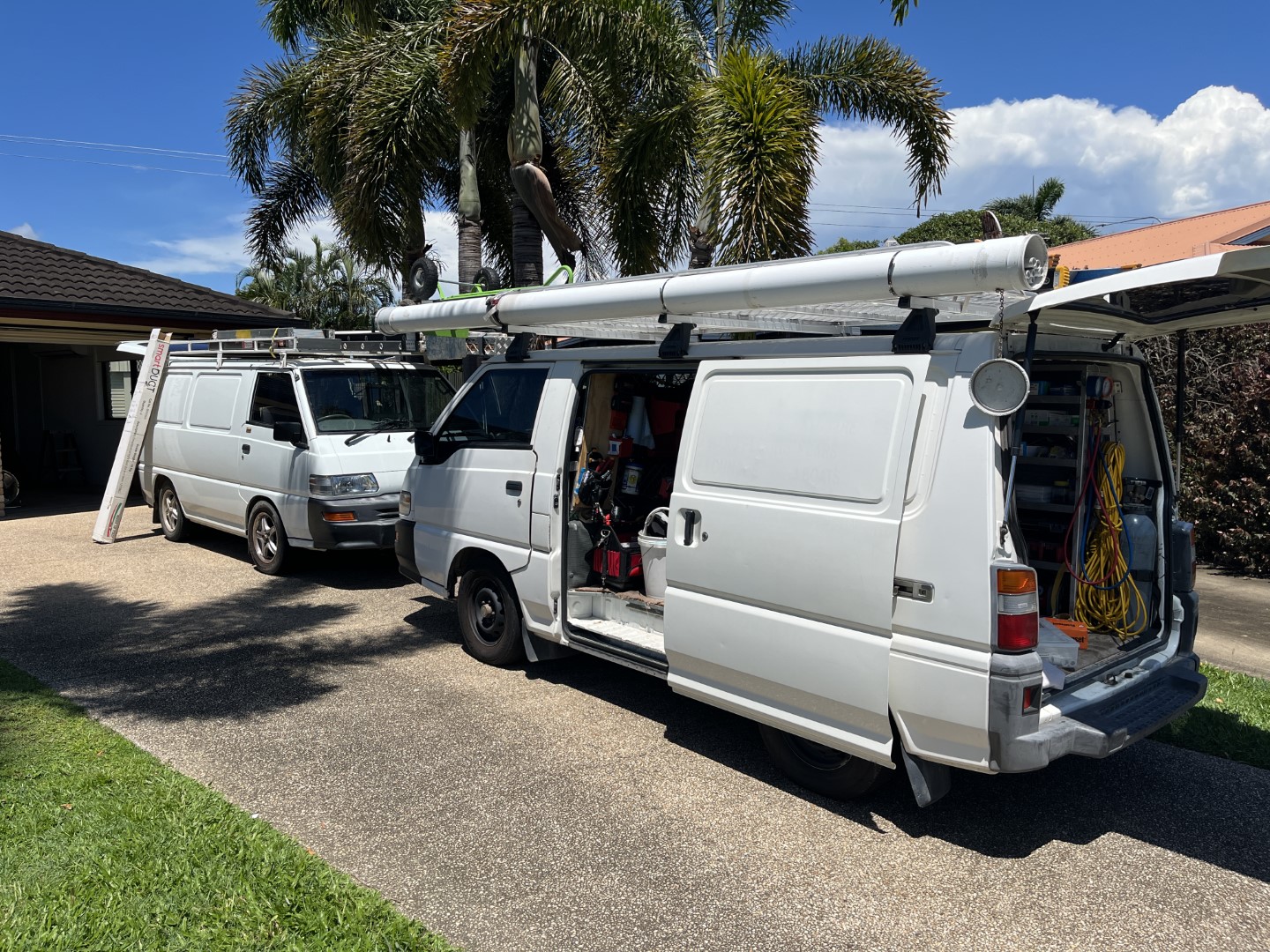 PowerControl Industries service vehicles parked at a residential property during an electrical installation