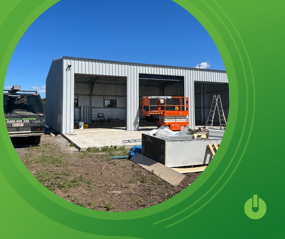 Electrical project site under construction with workshop framing, scissor lift and installation materials on location