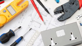 Electrical tools and a double power outlet arranged on a residential or commercial wiring plan
