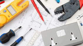 Electrical tools and a double power outlet arranged on a residential or commercial wiring plan
