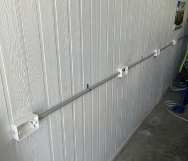 Wall-mounted conduit and backing plates prepared for multiple powerpoint installations in a residential or commercial space