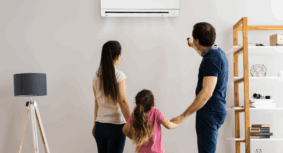 Family using a recently serviced wall-mounted split system air conditioner in their living room