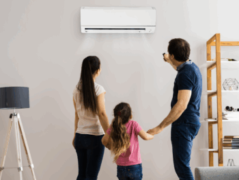 Family using a recently serviced wall-mounted split system air conditioner in their living room