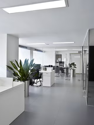 Modern open-plan office with ducted air conditioning vents integrated into ceiling design